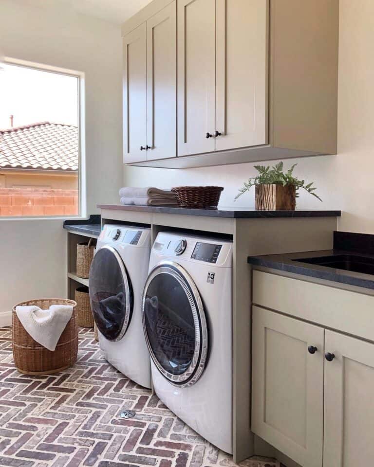 Beige Laundry Cabinets with Black Countertop - Soul & Lane