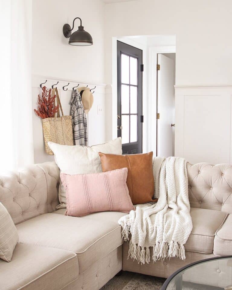 https://www.soulandlane.com/wp-content/uploads/2022/10/Beige-Tufted-Sofa-with-White-Pink-and-Brown-Leather-Throw-Pillows-768x961.jpg
