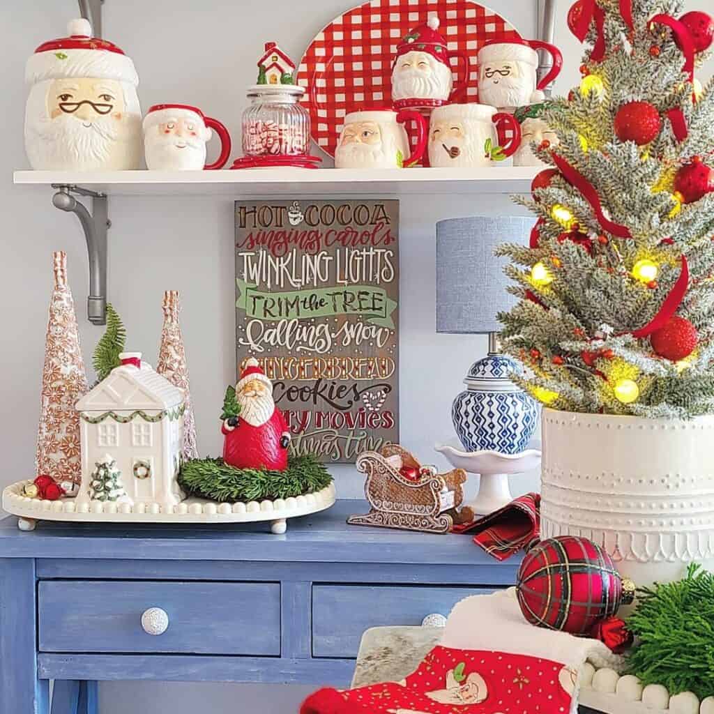 Santa Decorations Above a Blue Console Table - Soul & Lane