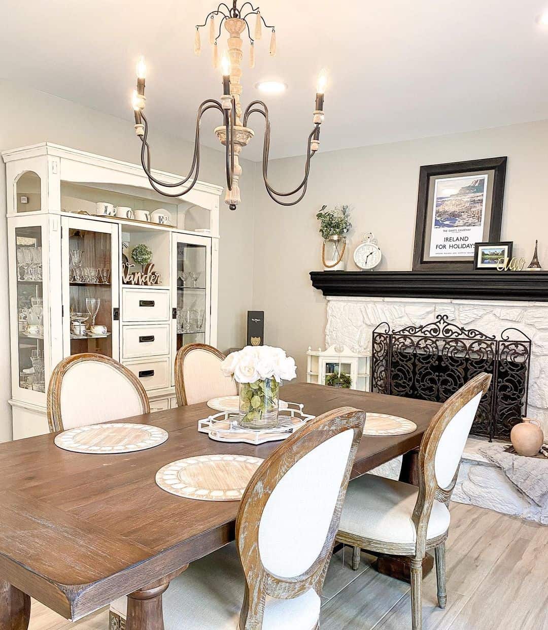 Dining Room With White Stone Fireplace - Soul & Lane