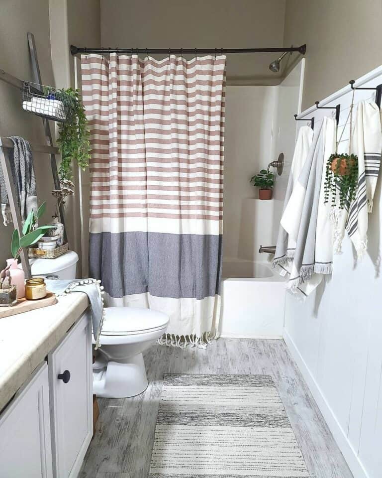 https://www.soulandlane.com/wp-content/uploads/2023/04/Boho-Bathroom-Featuring-a-Tasseled-Shower-Curtain-768x960.jpg