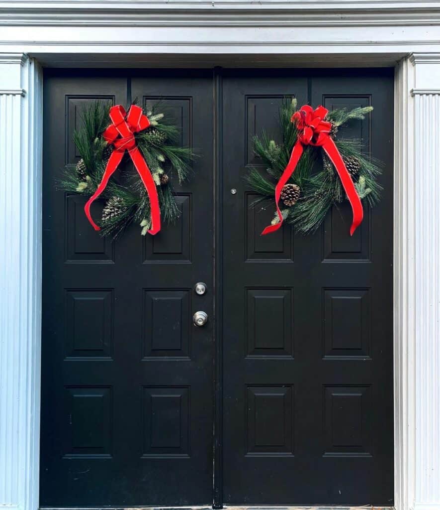 Bright Red Bows Tied to Door Wreaths - Soul & Lane